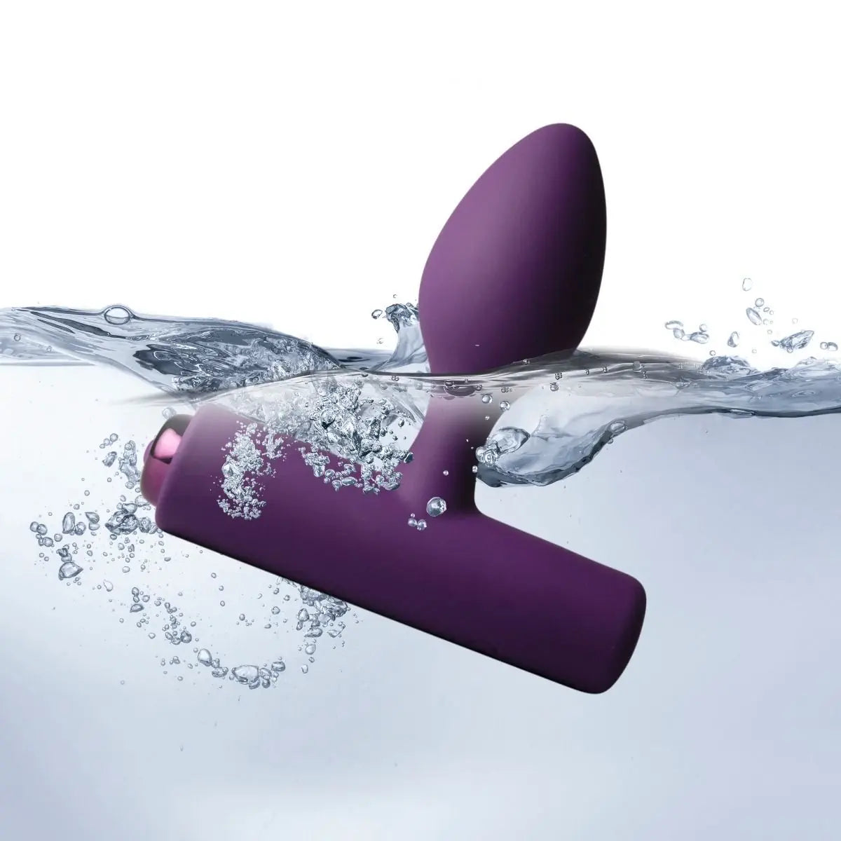 Purple silicone product partially submerged in water with bubbles around it.