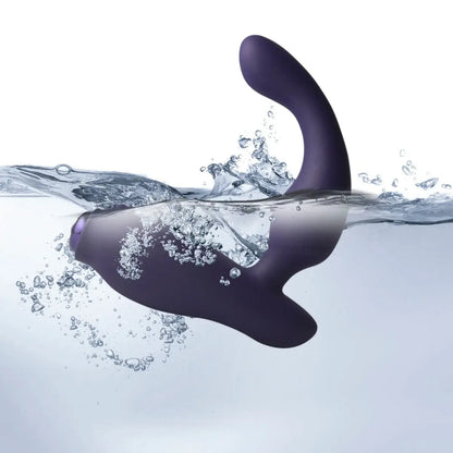 Purple silicone prostate product submerged in water with splashes on a white background