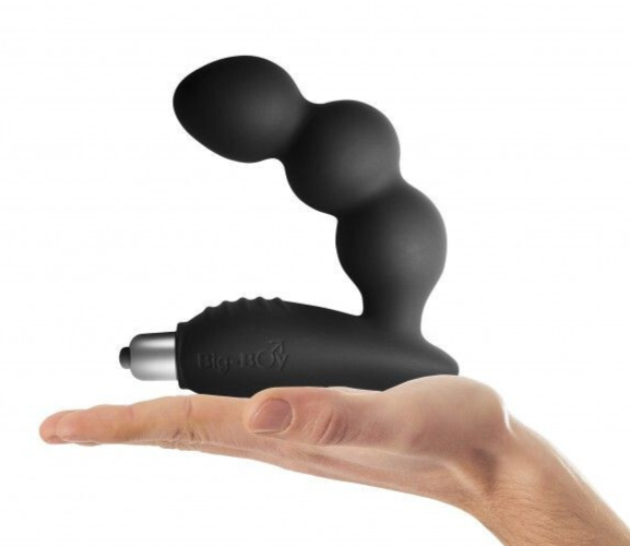 Black handheld prostate massager held in a hand on a white background