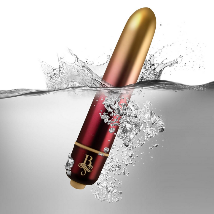 Red and gold cylindrical product with water splash on a gray background
