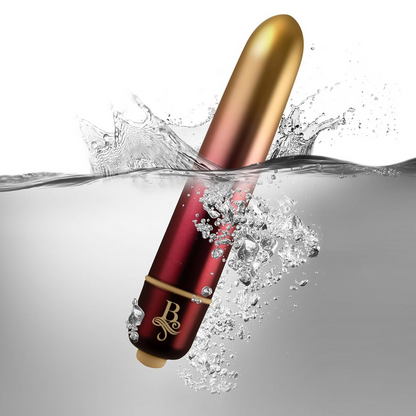 Red and gold cylindrical product with water splash on a gray background