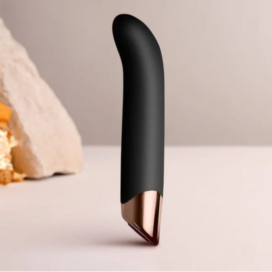 Black and rose gold electronic bullet vibrator on a neutral background