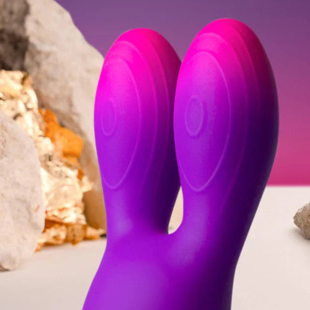 Purple silicone product with a natural rock and sand background