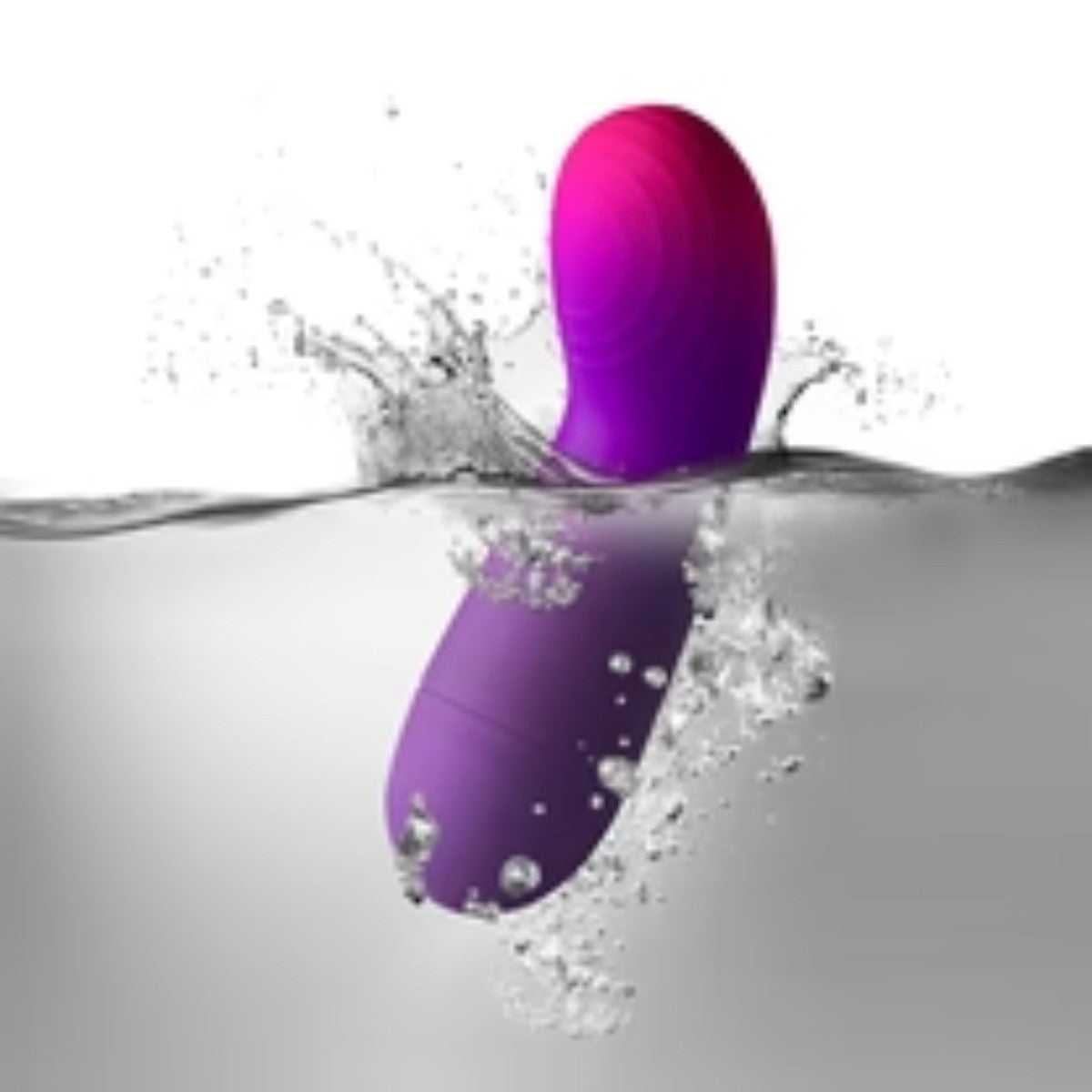 Purple and pink sex toy partially submerged in water with splashes.