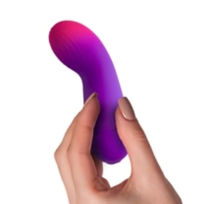 Purple and pink silicone massager held by a hand on a white background