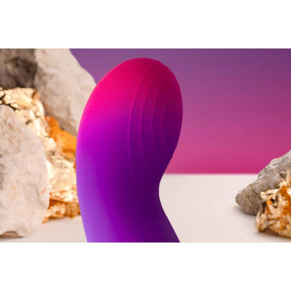 Purple and pink silicone product with a natural rock and shell background