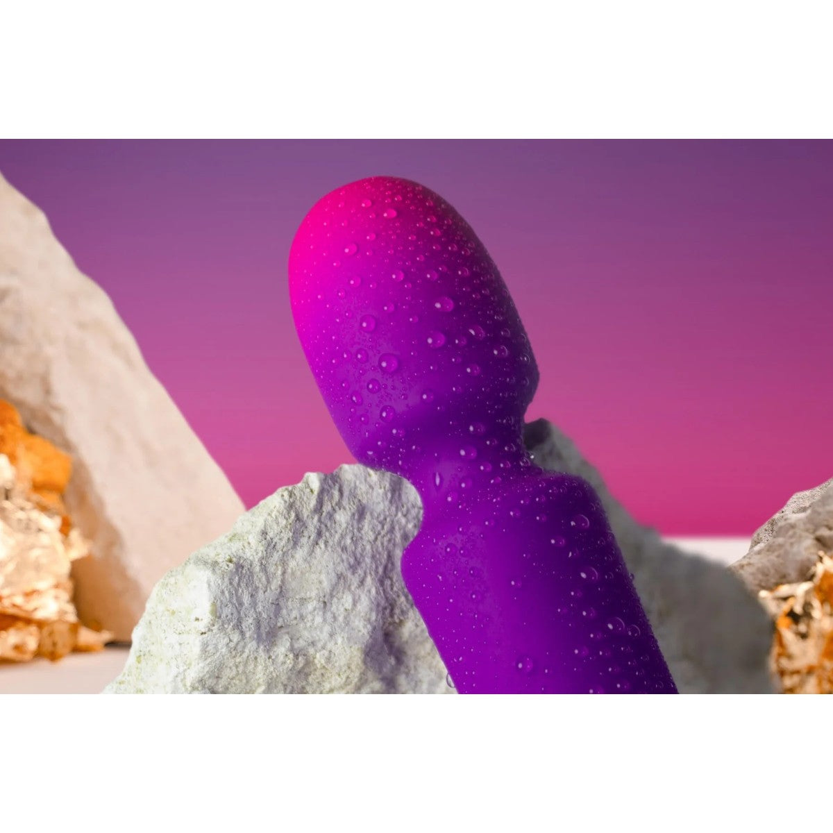 Purple object resembling a stylized human figure against a desert landscape with pink sky.