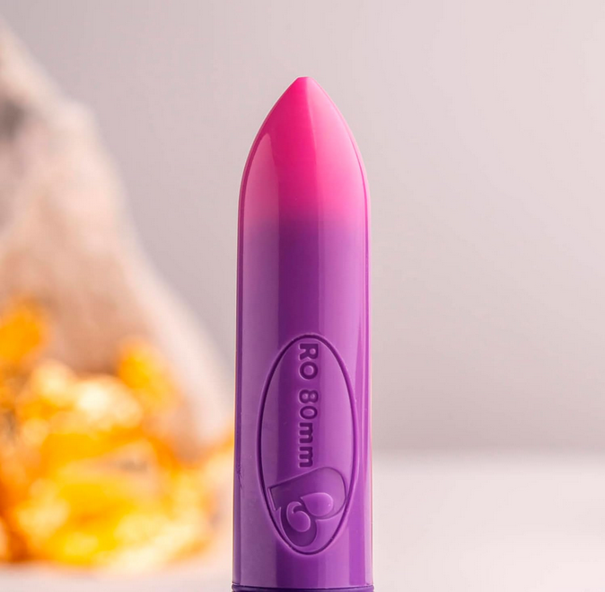 Purple and pink cylindrical object with 'RO 80 mm' text on a blurred background