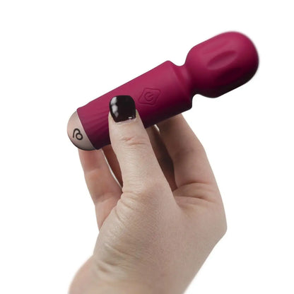 Hand holding a pink and black device against a white background