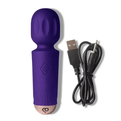 Purple silicone massage product with USB cable on a white background