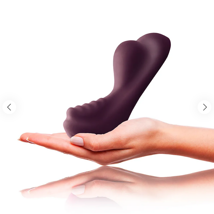 Purple silicone product held in a hand on a white background