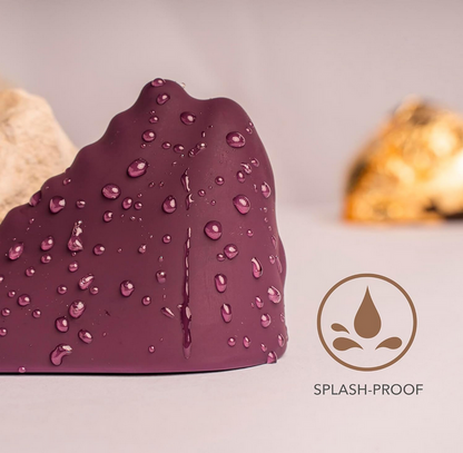 Purple object with water droplets and 'splash-proof' logo on a light background