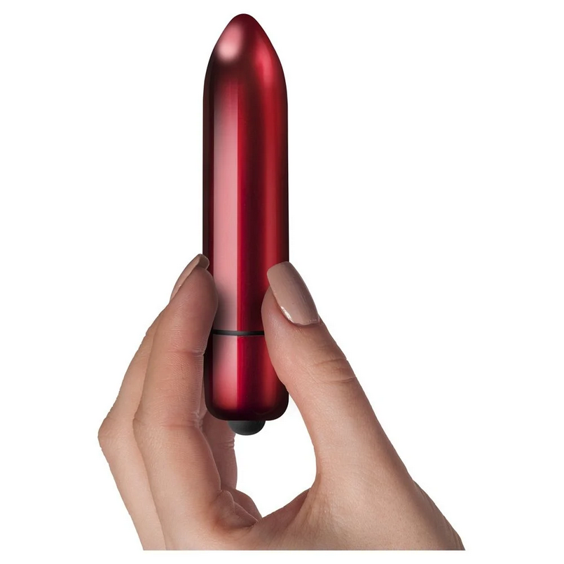 Red cylindrical object held in a hand against a white background