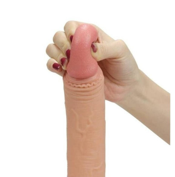 Hand holding a pink silicone dildo against a white background