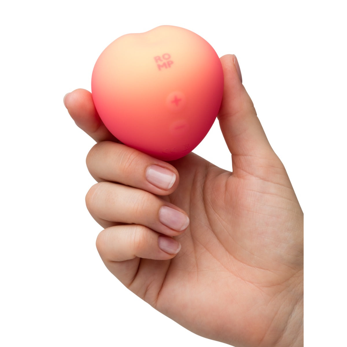 Hand holding a pink peach-shaped object with 'ROMP' text on a white background