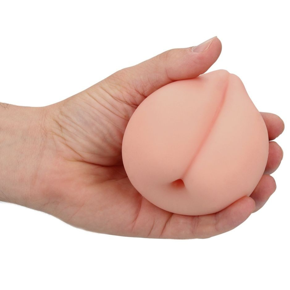 Hand holding a peach-shaped masturbator on a white background