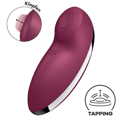 Purple handheld device with 'Klopfen' and 'Tapping' icons on a white background