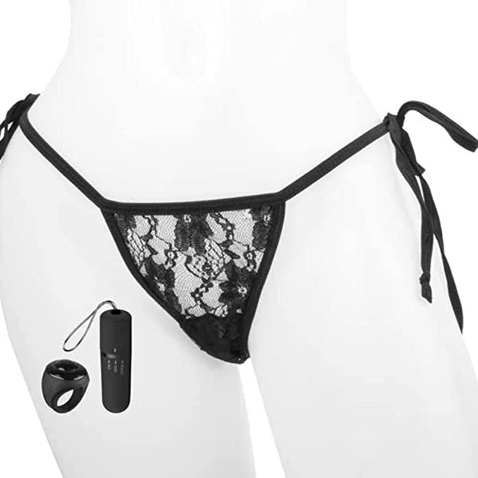 Black lace lingerie set with remote control vibrator and ring on a white background