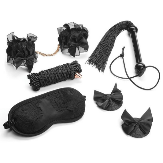 Collection of black bondage accessories including a blindfold, rope, and flogger on a white background