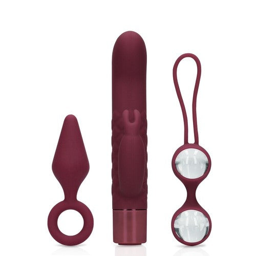 Set of three maroon silicone products on a white background