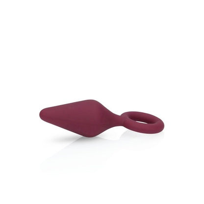 Red silicone anal plug on a white background