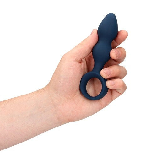 Hand holding a blue silicone prostate massager against a white background