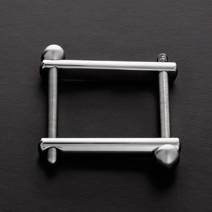 Metallic square frame with cylindrical ends on a dark gray background