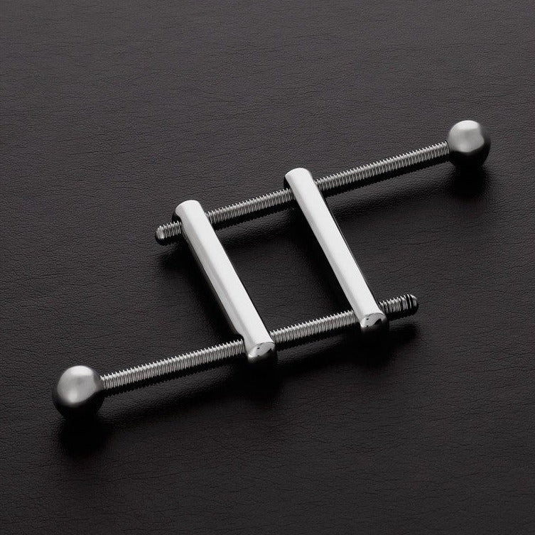 Metallic ladder-like object on a dark surface