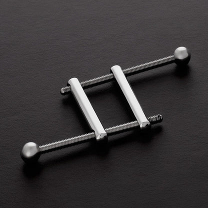 Metallic ladder-like object on a dark surface