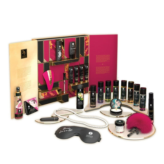 Massage set with various products including bottles, a eye mask, and a fuchsia brush on a white background.