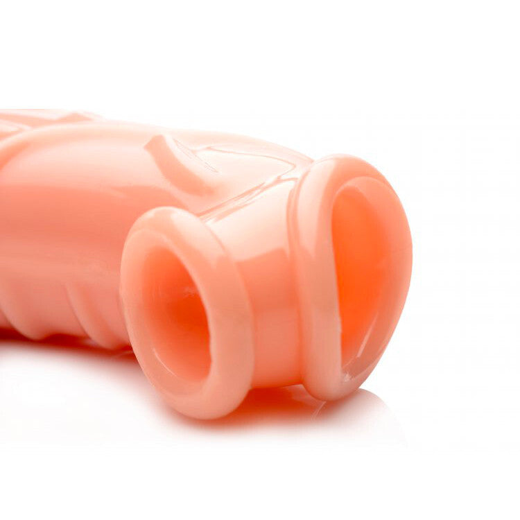 Close-up of a pink penis extender on a white background