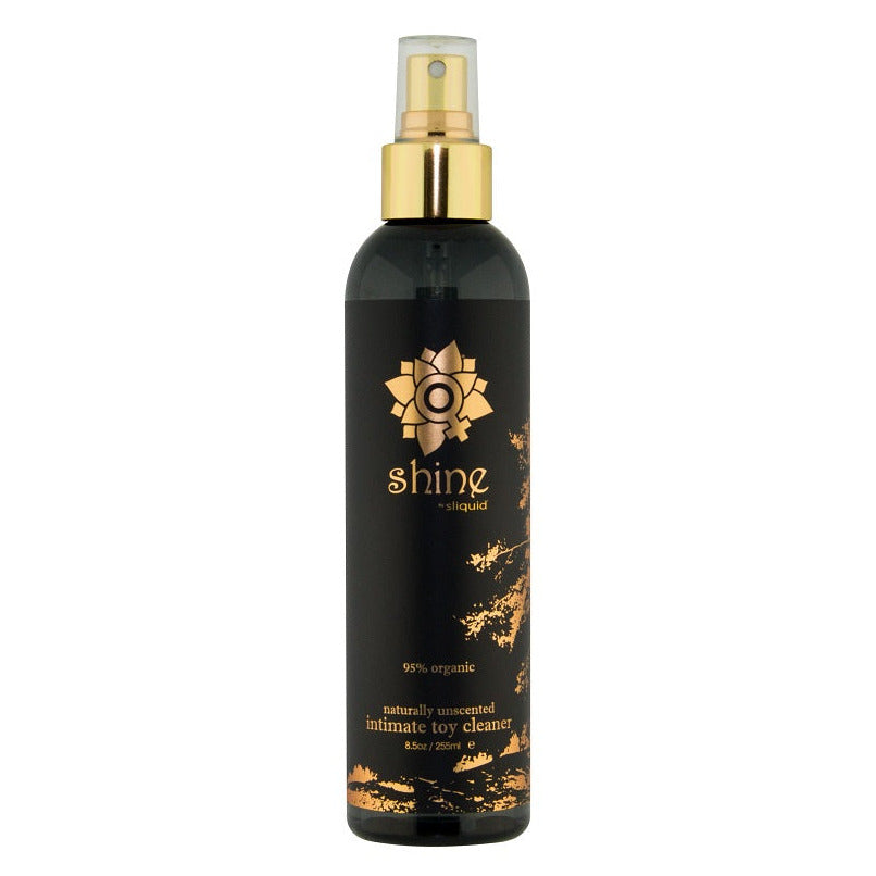 Black spray bottle with gold accents on a white background
