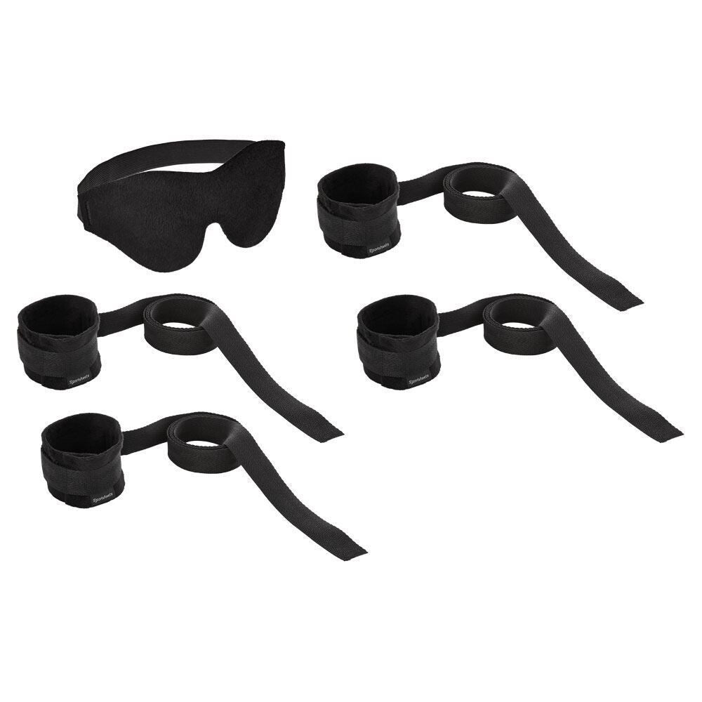 Black eye mask and bondage restraints on a white background