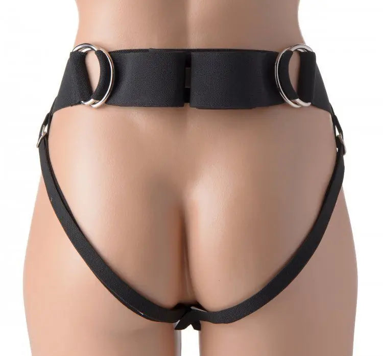 Black harness with metal rings on a mannequin against a white background