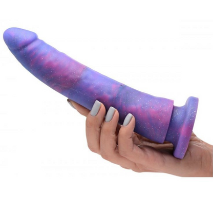 Hand holding a purple and pink sex toy with a white background