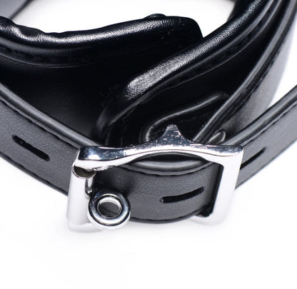 Close-up of a black leather belt with a silver buckle on a white background