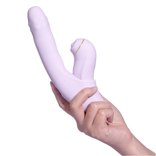Hand holding a purple sex toy against a white background