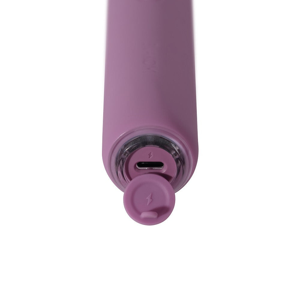 Close-up of a purple electronic device with charging port on a white background
