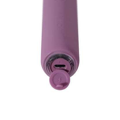 Close-up of a purple electronic device with charging port on a white background