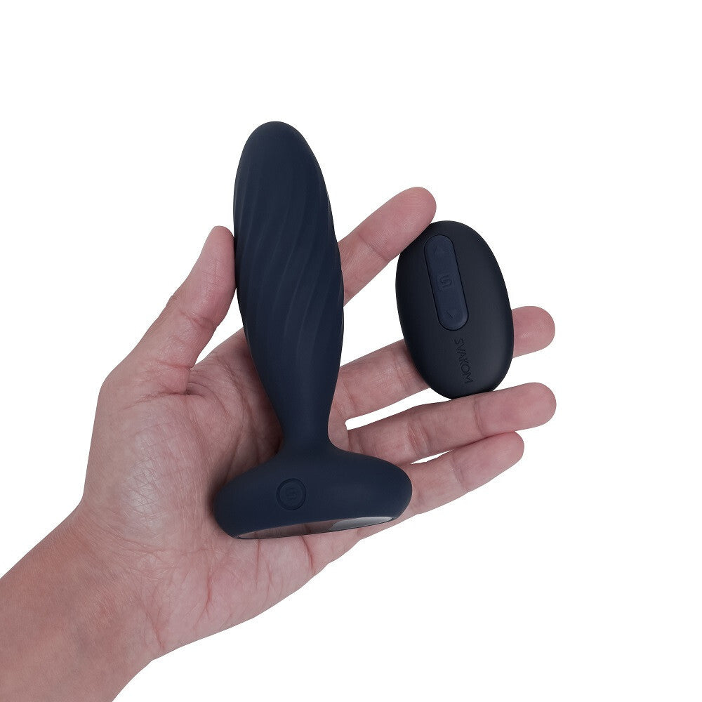 Black silicone product held in a hand with another similar product on a white background