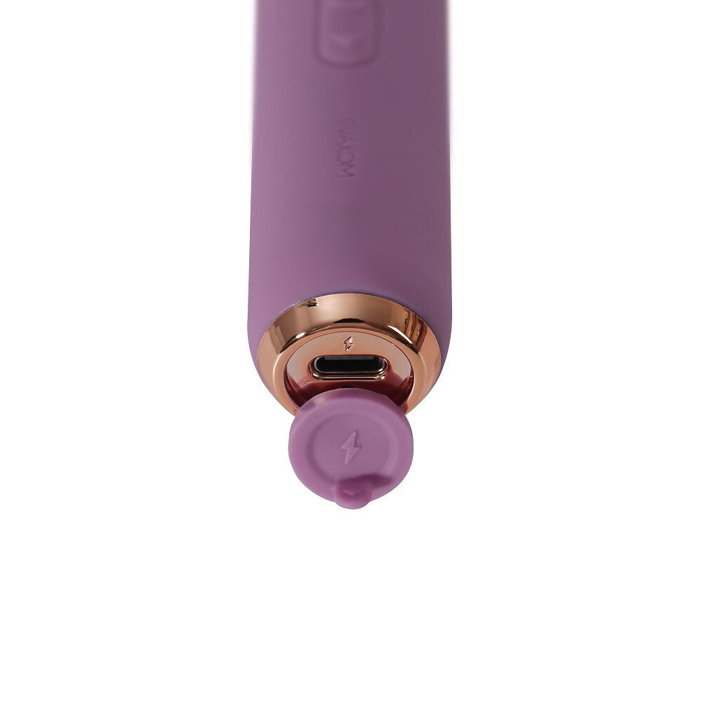 Purple electronic device with charging port on a white background