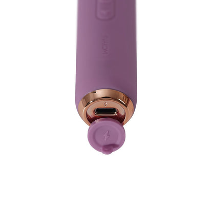 Purple electronic device with charging port on a white background