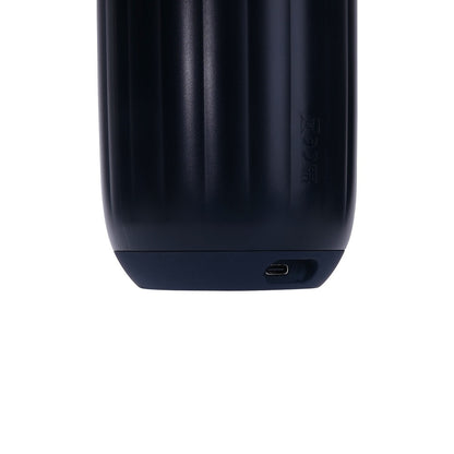Close-up of a black electronic device with a USB-C port on a white background
