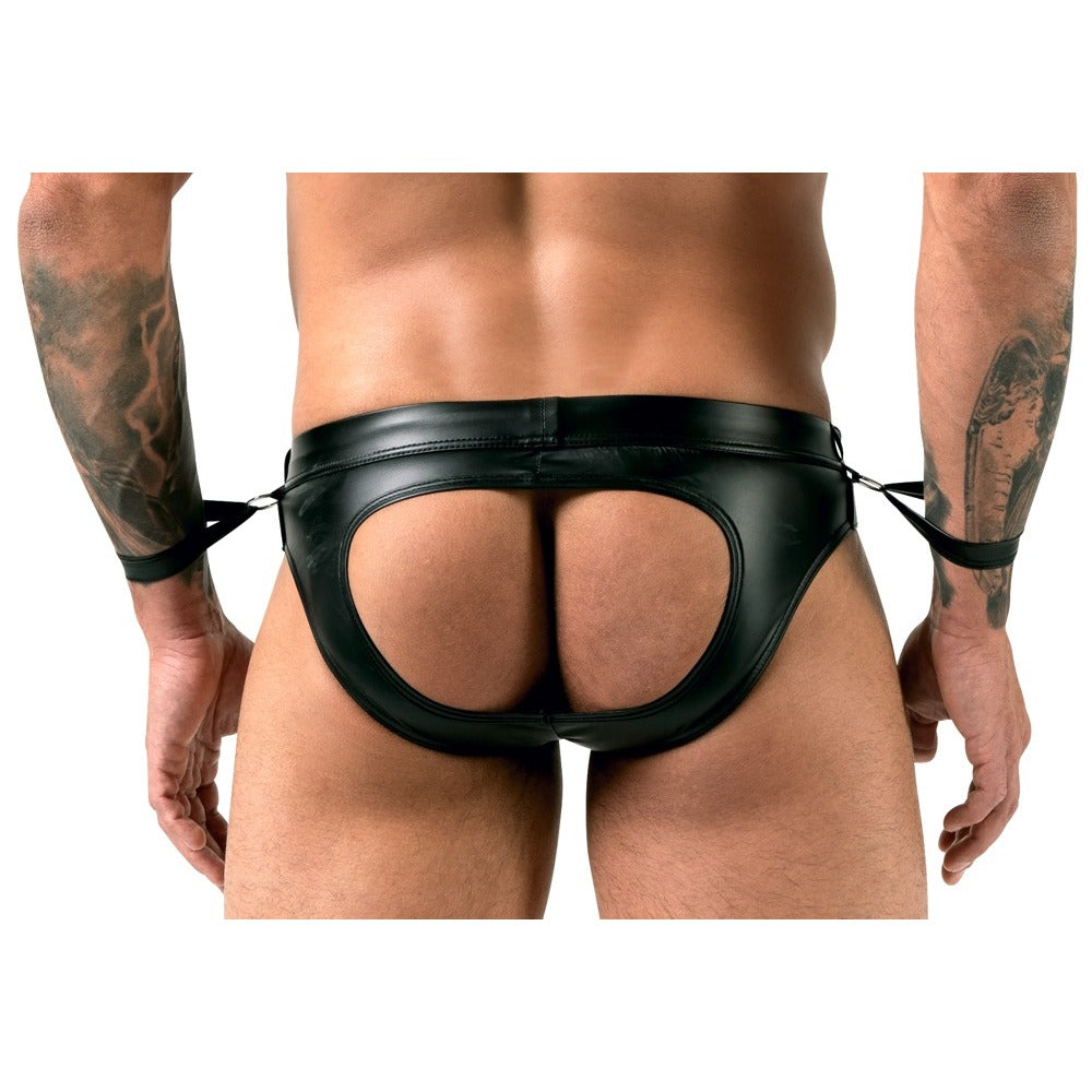 Black leather thong worn by a person with tattoos on a white background