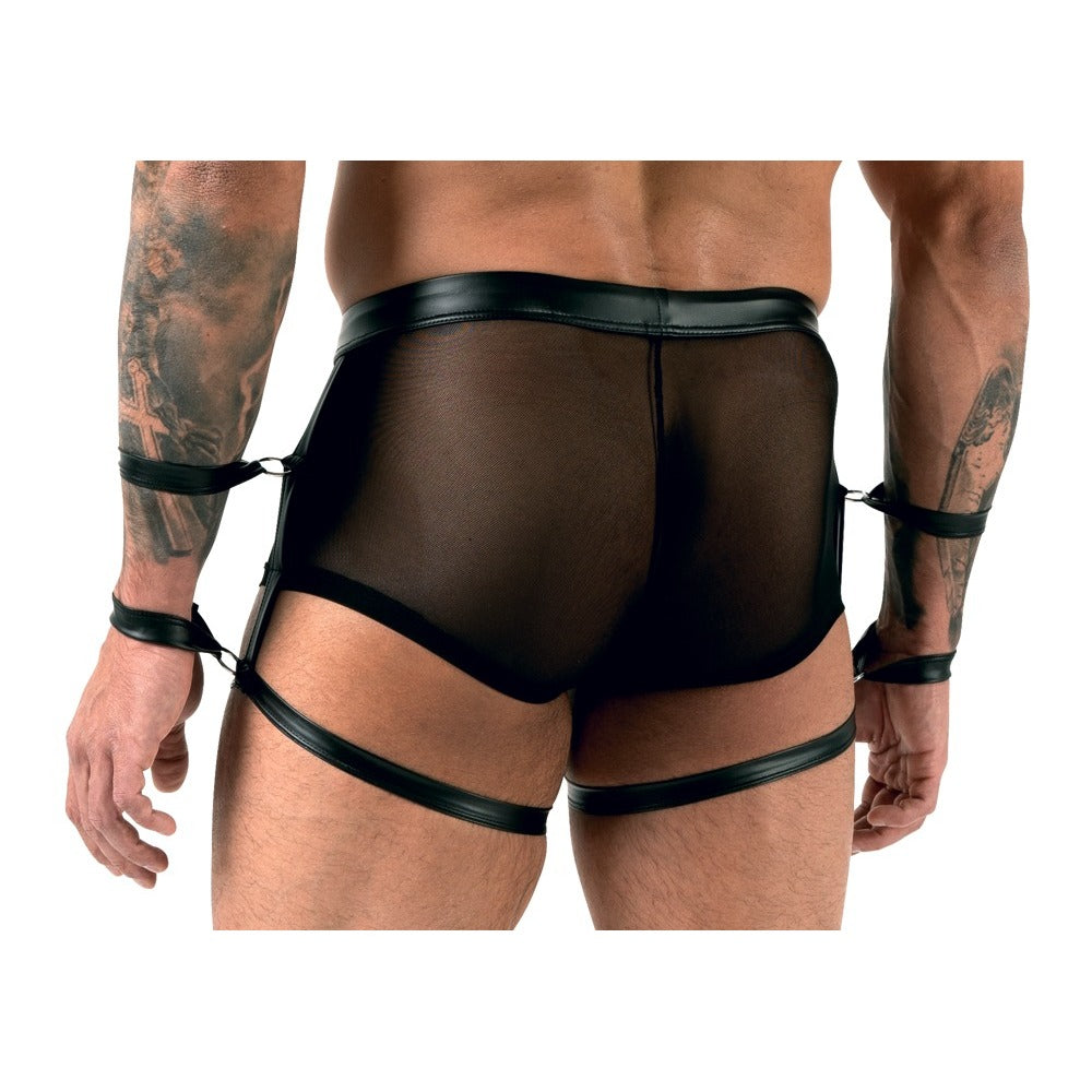 Black leather harness worn by a person on a white background