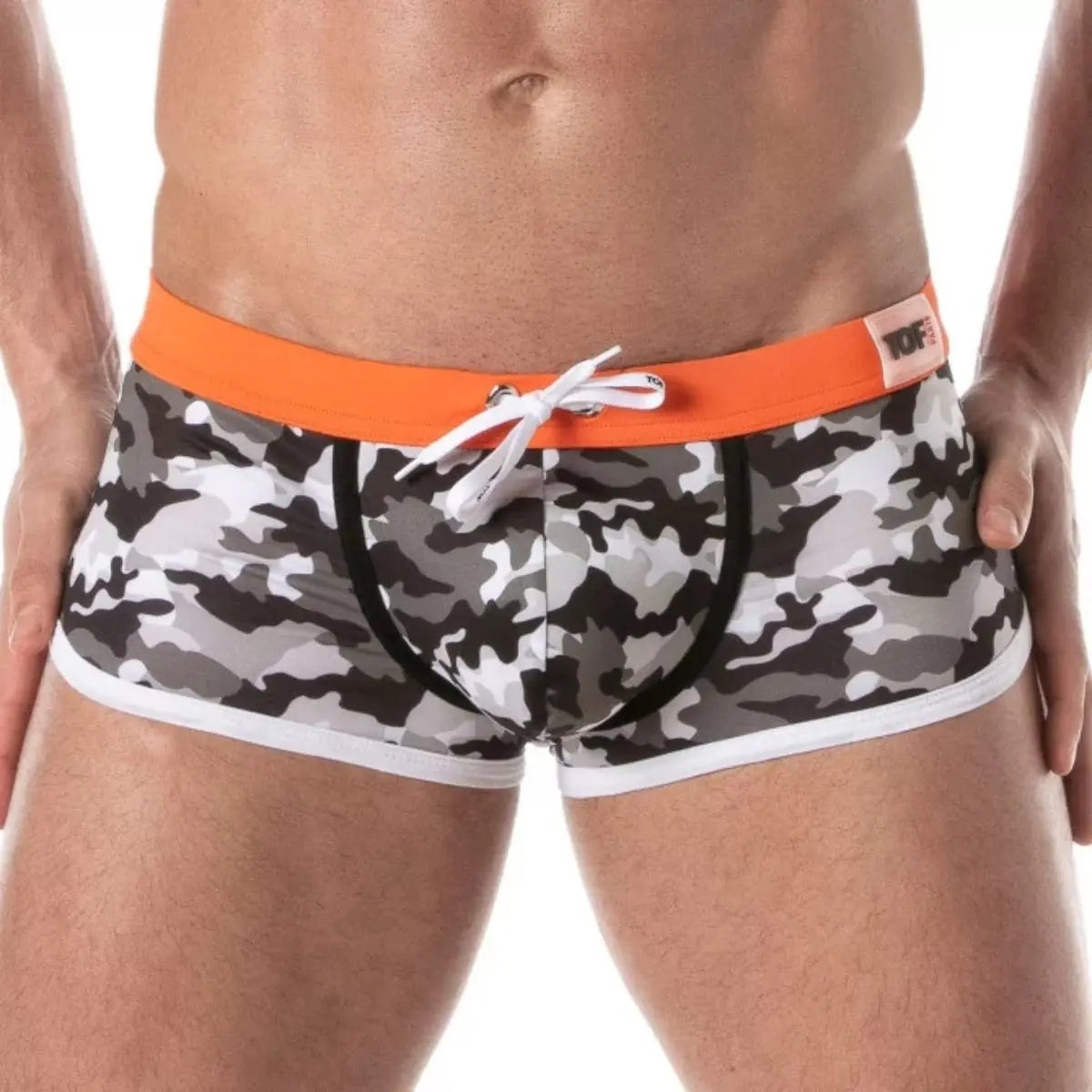 Camouflage swim shorts with orange waistband on a white background