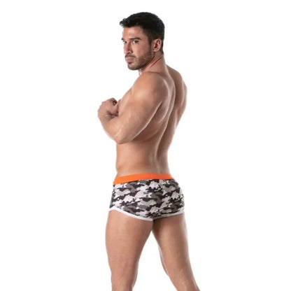 Man wearing camouflage swim shorts on a white background