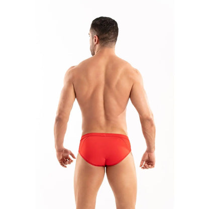 Man wearing red swim briefs on a white background