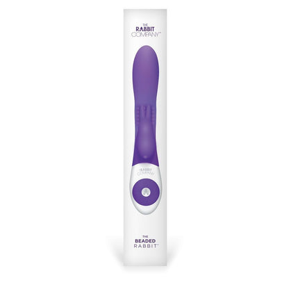 Purple and white electronic massage device in packaging on a white background