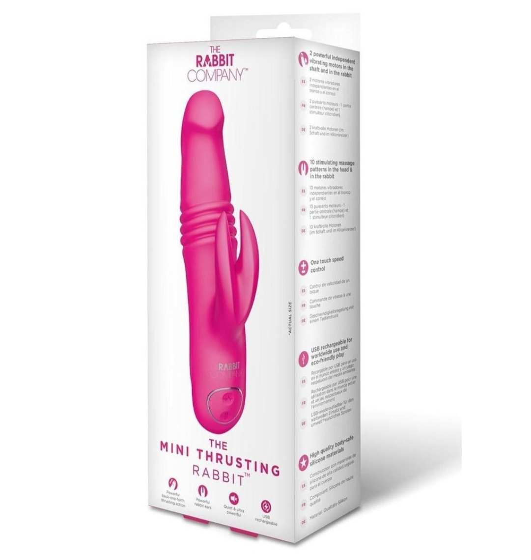 Pink mini thrusting rabbit sex toy with packaging on a white background